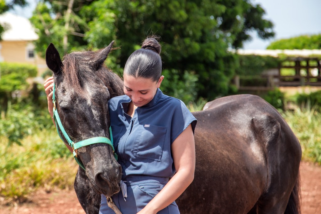 Image of a female DVM student with a horse