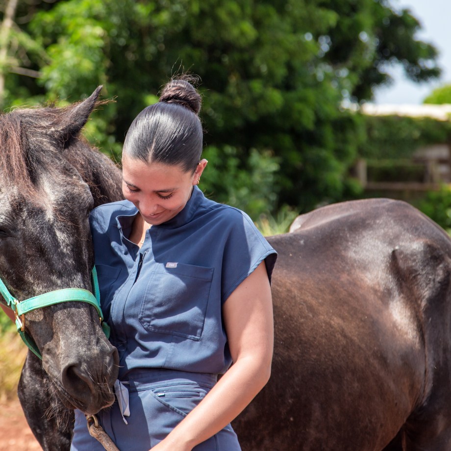 Image of a female DVM student with a horse