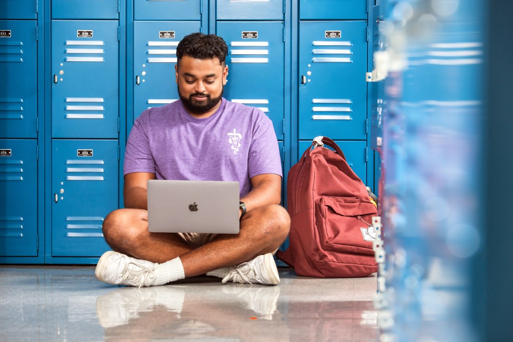 Image of student sitting near lockers