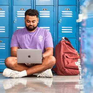Image of student sitting near lockers