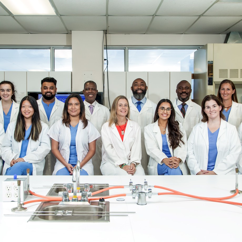SMU Veterinary Faculty and Students pose for a group picture in microbiology lab