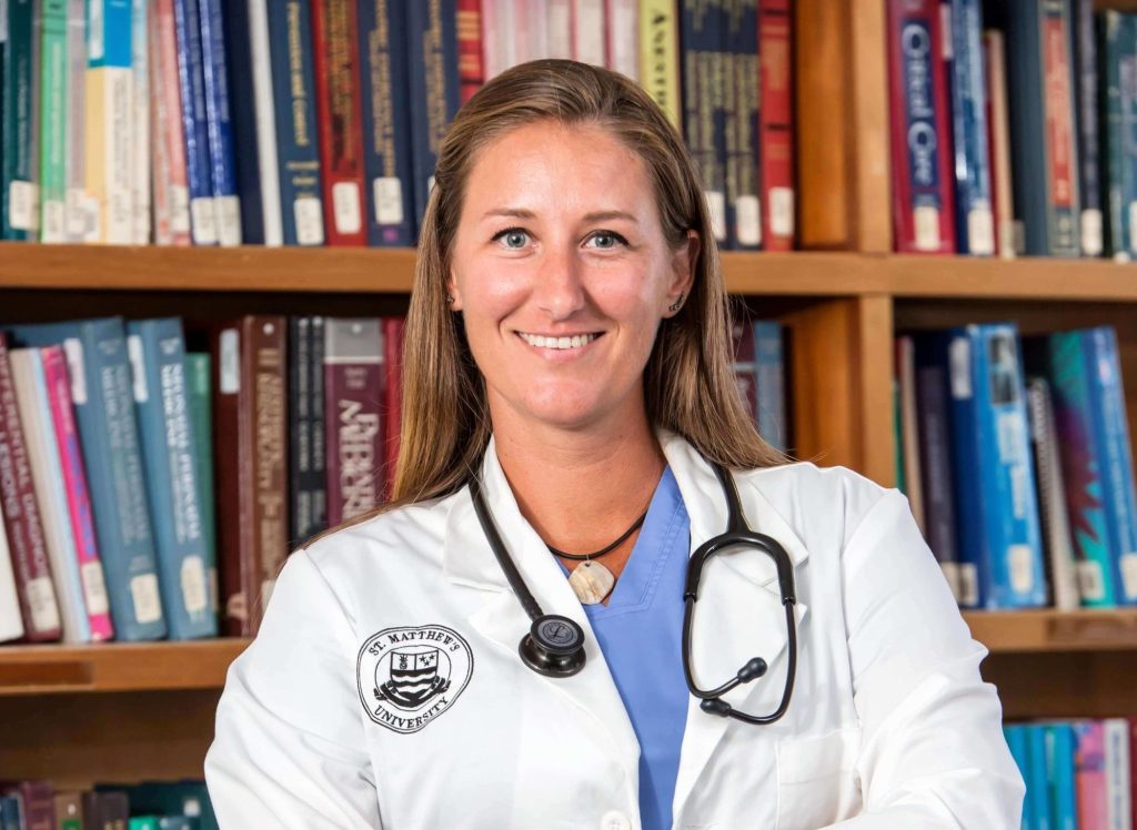 female vet student in white coat